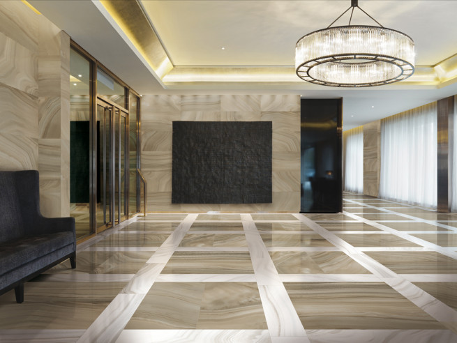 Modern lobby with large chandelier and marble floors