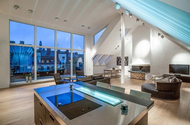penthouse-interior-design-equipped-with-kitchen-table-with-stainless-steel-surface-and-electric-stove-top